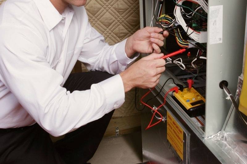 HVAC technician servicing a furnace